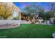 Landscaped backyard with a waterfall, lush greenery, and a grassy area at 1535 E Calavar Dr, Phoenix, AZ 85022