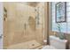 Shower with glass enclosure and decorative glass block window at 1535 E Calavar Dr, Phoenix, AZ 85022