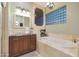 Bathroom boasts a large soaking tub, double vanity, and a glass shower at 1535 E Calavar Dr, Phoenix, AZ 85022