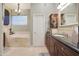 Elegant bathroom with a soaking tub, double vanity, and granite countertops at 1535 E Calavar Dr, Phoenix, AZ 85022