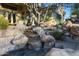 Serene backyard waterfall feature with stone accents and lush landscaping at 1535 E Calavar Dr, Phoenix, AZ 85022