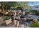 Relaxing backyard oasis featuring a natural stone waterfall and pond at 1535 E Calavar Dr, Phoenix, AZ 85022