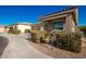 Inviting curb appeal featuring a covered porch and well-manicured landscaping at 1744 E 16Th Ave, Apache Junction, AZ 85119