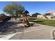 playground with play structures and grassy area at 1744 E 16Th Ave, Apache Junction, AZ 85119