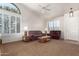 Living room with brown carpet, couches, and a coffee table at 20020 N 21St St, Phoenix, AZ 85024