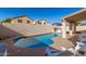 Inviting kidney-shaped pool with a large patio area at 20020 N 21St St, Phoenix, AZ 85024