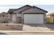 Newly built home with gray exterior, two-car garage, and small front yard at 2665 E Santa Ynez Dr, Casa Grande, AZ 85194