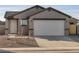 Newly built home with gray exterior, two-car garage, and small front yard at 2665 E Santa Ynez Dr, Casa Grande, AZ 85194