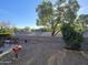 Landscaped backyard with seating area and desert views at 31627 N Poncho Ln, San Tan Valley, AZ 85143