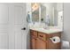 Small bathroom with single sink and wood cabinet at 31627 N Poncho Ln, San Tan Valley, AZ 85143