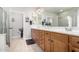 Bathroom with double sinks, large vanity, and shower at 31627 N Poncho Ln, San Tan Valley, AZ 85143