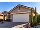 One-story home with a large garage and a tall cactus at 31627 N Poncho Ln, San Tan Valley, AZ 85143