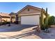 Single-story home featuring a large garage and drought-tolerant landscaping at 31627 N Poncho Ln, San Tan Valley, AZ 85143