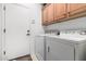 Laundry room with washer, dryer, and overhead cabinets at 31627 N Poncho Ln, San Tan Valley, AZ 85143