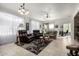 Bright living room with comfortable seating and a view to the kitchen at 31627 N Poncho Ln, San Tan Valley, AZ 85143