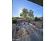 Relaxing covered patio with seating area and desert landscaping at 31627 N Poncho Ln, San Tan Valley, AZ 85143