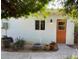 White studio with orange door and string lights at 3844 N 13Th Ave, Phoenix, AZ 85013