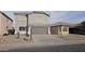 Two-story house with gray exterior, two-car garage, and desert landscaping at 40092 W Hayden Dr, Maricopa, AZ 85138