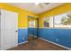 Bedroom with yellow and blue walls, carpet, and mirrored closet at 4343 E Downing St, Mesa, AZ 85205