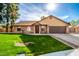 Brick ranch home with a 2-car garage and well-manicured lawn at 4343 E Downing St, Mesa, AZ 85205