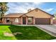 Brick ranch home with a 2-car garage and a lush green lawn at 4343 E Downing St, Mesa, AZ 85205