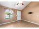 Living room with vaulted ceiling, tile floors, and a ceiling fan at 4343 E Downing St, Mesa, AZ 85205