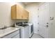 Bright laundry room features washer, dryer, cabinets, and utility sink at 7479 E Sunset Sky Cir, Scottsdale, AZ 85266