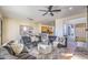 Open living room featuring a circular sectional sofa and stone fireplace at 7479 E Sunset Sky Cir, Scottsdale, AZ 85266