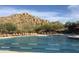 Community pool with mountain backdrop and ample lounge chairs at 7479 E Sunset Sky Cir, Scottsdale, AZ 85266