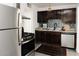 Kitchen with stainless steel appliances and dark wood cabinets at 837 E Echo Ln, Phoenix, AZ 85020