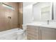 Stylish bathroom with light wood vanity, toilet, and bathtub at 13924 E Windstone Trl, Scottsdale, AZ 85262