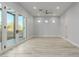 Bright and airy bedroom with wood flooring and access to a private bathroom at 13924 E Windstone Trl, Scottsdale, AZ 85262