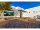 Modern home's exterior showcases a minimalist design with a sleek entryway and desert landscaping at 13924 E Windstone Trl, Scottsdale, AZ 85262