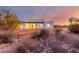 Back exterior of modern home at sunset, showcasing clean lines at 13924 E Windstone Trl, Scottsdale, AZ 85262