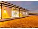 Back exterior of modern home with covered patio at dusk at 13924 E Windstone Trl, Scottsdale, AZ 85262