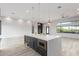 Modern kitchen island with built-in microwave and wine cooler at 13924 E Windstone Trl, Scottsdale, AZ 85262
