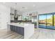 Spacious kitchen with island, stainless steel appliances, and a view of the desert landscape at 13924 E Windstone Trl, Scottsdale, AZ 85262