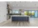 Open concept kitchen with large island, stainless steel appliances, and access to patio at 13924 E Windstone Trl, Scottsdale, AZ 85262