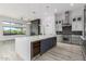 Modern kitchen with large island, wine fridge, stainless steel appliances and breakfast bar at 13924 E Windstone Trl, Scottsdale, AZ 85262