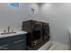 Laundry room with dark-colored washer and dryer and a sink at 13924 E Windstone Trl, Scottsdale, AZ 85262