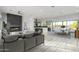 Open-concept living space with a modern fireplace, kitchen island, and dining area at 13924 E Windstone Trl, Scottsdale, AZ 85262