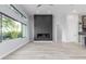 Living area features a modern fireplace, large windows, and light hardwood floors at 13924 E Windstone Trl, Scottsdale, AZ 85262