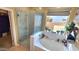 Spa-like bathroom with soaking tub and walk-in shower at 1950 N 142Nd Ave, Goodyear, AZ 85395