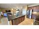 Open kitchen with large island, stainless steel appliances, and views to living room at 1950 N 142Nd Ave, Goodyear, AZ 85395