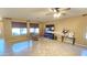 Living room with tile floors, recliner, and a large TV at 1950 N 142Nd Ave, Goodyear, AZ 85395