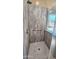 Walk-in shower with modern gray wall panels at 1950 N 142Nd Ave, Goodyear, AZ 85395