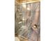 Walk-in shower with marble-like walls and seat at 1950 N 142Nd Ave, Goodyear, AZ 85395