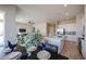 Dining area showcasing the open-concept layout with the kitchen island, living room, and natural lighting at 28205 N 213Th Dr, Wittmann, AZ 85361