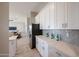 Kitchen showcasing quartz countertops, tiled backsplash, stainless steel appliances, and an open view to the living room at 28205 N 213Th Dr, Wittmann, AZ 85361