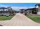 A community space with a pool, umbrellas, tables, and a walkway in a newly constructed neighborhood at 3339 E Audrey Dr, San Tan Valley, AZ 85143